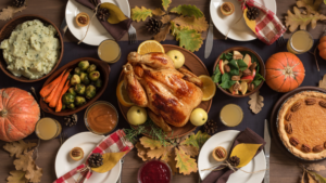 photo from above a dining room table on Thanksgiving showing turkey and various sides