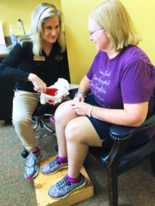 Photo showing one-on-one patient care the Cantrell Center in Warner Robins, GA near Macon, GA. Physical therapist points to a model of a pelvis while working with a patient.